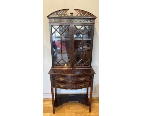 A Regency style mahogany display cabinet bookcase by T.Edmands of London, the scalloped shaped top above two bow fronted draw