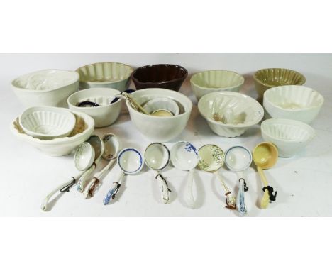 A collection of early 20th century ceramic jelly moulds, together with a collection of early porcelain soup/sauce ladles. 