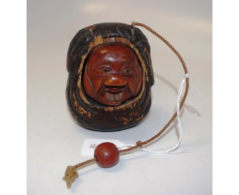 Japanese carved boxwood netsuke &amp; Inro the netsuke depicting a carved figural head inside a nut shell inro with bead to e