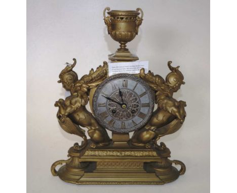 Antique French gilt metal mantle clock neo-classical  decoration, with dial flanked by mythical creatures, on stepped base, w