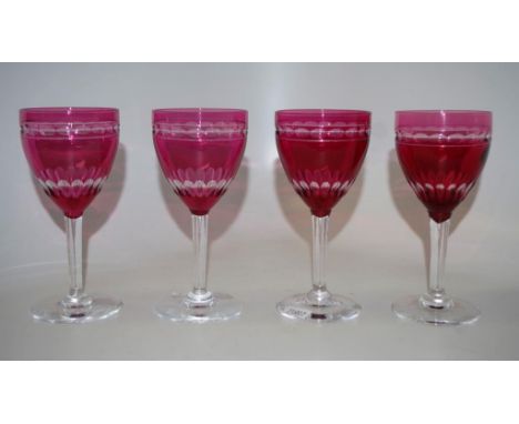 Set four ruby glass wine glasses each with faceted cameo glass decoration, (height 14cm approx, each).