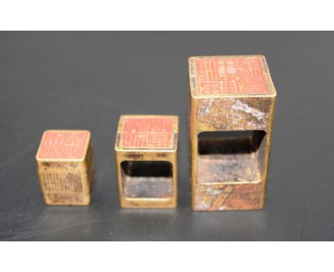 Good Chinese brass seal comprising 3 parts of brass seal, in original cloth carry bag, (height 5cm approx).
