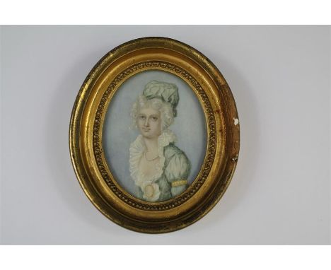 An Antique Circular Portrait Miniature. The miniature depicting a young woman, approx 75 x 95mm, presented in a gold-painted 