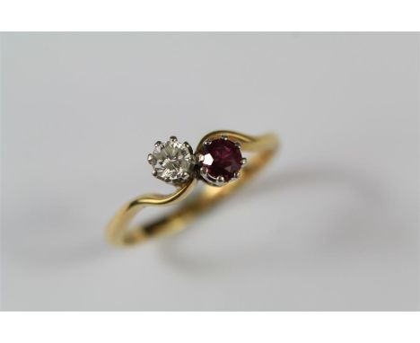 An 18ct Yellow Gold Diamond and Ruby Ring. The cross-over ring set with approx 20pts dias and a 3.8mm ruby, size O, approx 2.