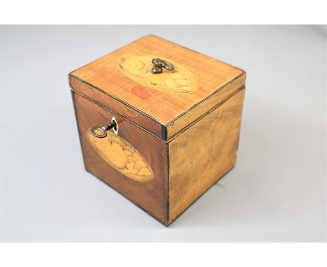 A 19th Century Tea Caddy. The mahogany caddy worked with decorative shell motif inlay, ivory lock plate and finial, approx 12