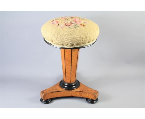 An Antique Adjustable Revolving Piano Stool. The veneered burr-walnut stool set on a hexagonal column support with tripod fee