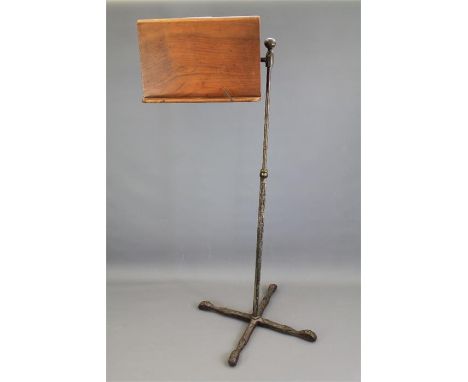 A John Carter 'Literary Machine' Music Stand. The stand on a wrought iron tripod base, with adjustable bracket, approx 125 cm