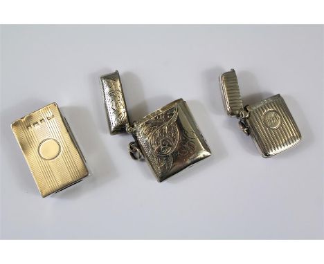 A Pair of Silver Vesta Cases. This lot also includes an engine-turned silver match-box holder, all Birmingham hallmark, appro