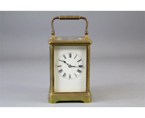 A Brass Carriage Clock. The clock having a white enamel face with Roman dial, the movement back plate stamped 17888 bearing t