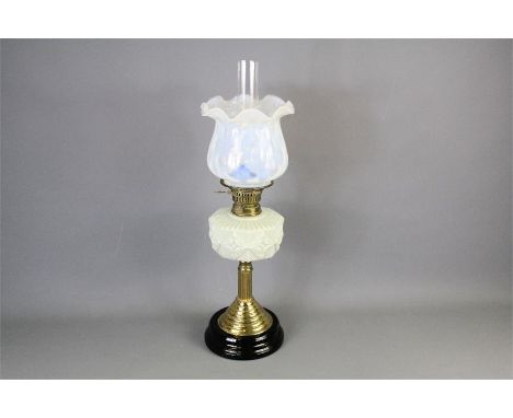 A Victorian Oil Lamp. The lamp with brass base, cream glass reservoir and cream vaseline glass shade, with glass funnel, appr