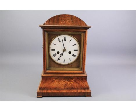 Antique English Bracket Clock. The mahogany clock with decorative foliate inlay, white enamel face and Roman dial, approx 24 