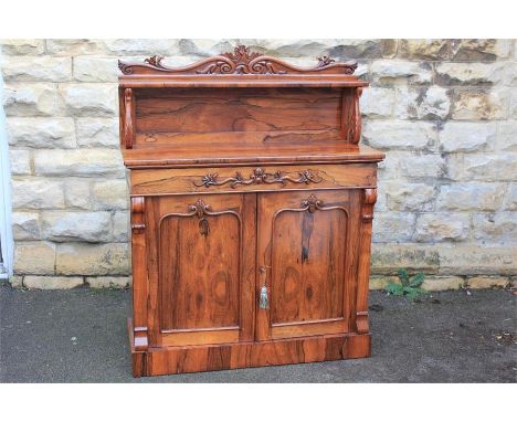A Victorian Rosewood Chiffonier. The chiffonier with galleried shelf on foliate supports, single width drawer above double cu