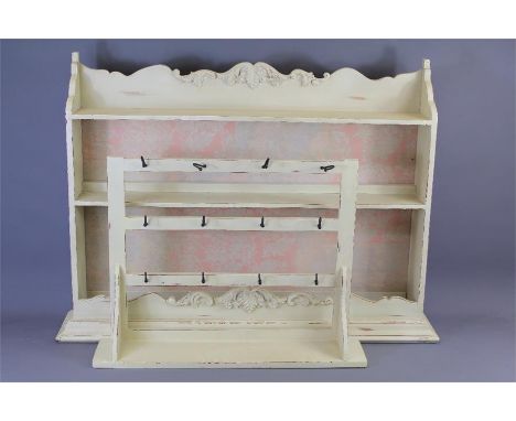 A Cream-Painted Gustavian-Style Wooden Shelf. The shelf approx 90 x 72 x 14 cms together with a smaller shelf with coat rack,