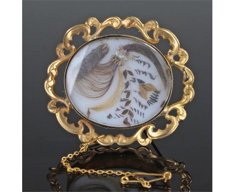 19th Century pinchbeck brooch, the oval panel set with hair, swag border, 50mm wide