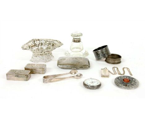 A silver pierced heart shaped basket, a cigarette case, a silver mounted inkwell, napkin rings, silver ingot, pocket watch, t