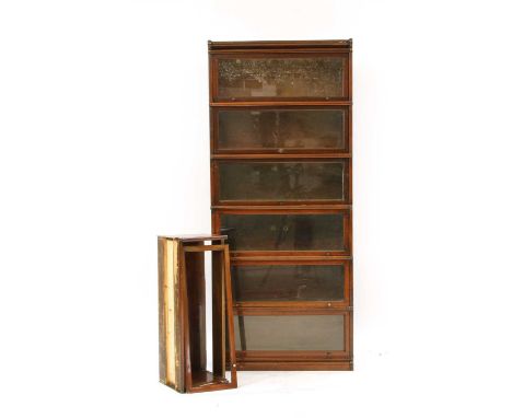 A seven section globe wernicke bookcase , with glazed front panels, 86.5cm wide, 29.5cm deep, 245cm high, with panel lacking 