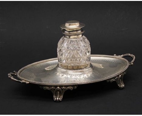 A Victorian silver two handled inkstand, By Messrs Baunarus, London, 1873, the oval base engraved with a band of chainmail an