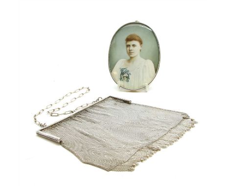 An early 20th Century miniature of a lady , on ivory, 12cm x 8.8cm, together with a silver mesh purse, T K &amp; Co, London I