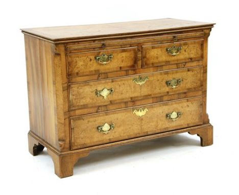 An 18th Century and later low chest, with a brushing slide over two short and three long drawers and on bracket feet, 104cm w