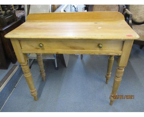A Victorian pine side table with raised back having one long drawer above ring turned legs 