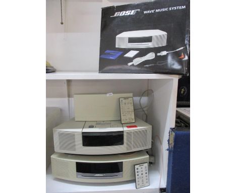 A Bose CD player in white, a Bose radio in white and other Bose items 