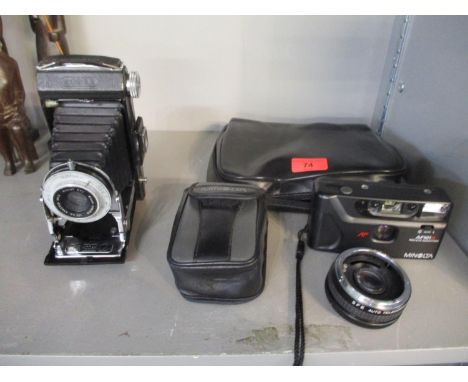 Cameras to include a Kodak Six 20 folding camera with Mount 370 100mm Anester F 6.3 lens, a Minolta AF101R camera, and a SFE 