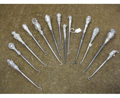 Thirteen silver handled button hooks to include two with leopards heads, an owl and Punch, total weight 440g 