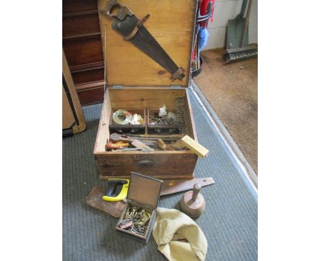 A stained vintage pine tool box containing wooden handled tools, door furniture and other items 