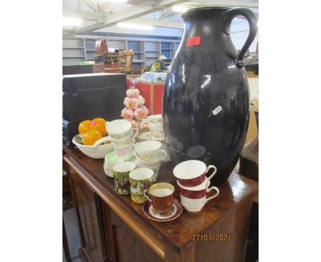 A tall black painted pottery jug marked Jasba together with two Continental painted pottery centre pieces in the form of bowl