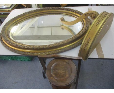 An early 20th century gilt oval wall mirror together with a reproduction gold painted wall shelf and an oak three tier foldin