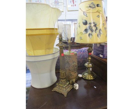 A vintage printers block cylinder roll converted into a table lamp together with a pair of brass table lamps 