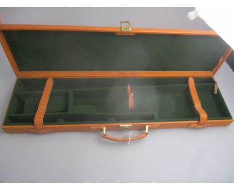 A Gunmark brown leather carrying case for a 30" barrel shotgun