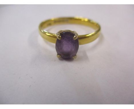 A 22ct gold and amethyst dress ring 3.9grams total weight, ring size UK letter U 