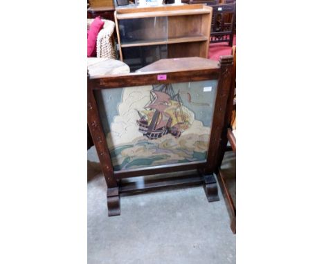 An oak firescreen with embroidered banner. 27'' wide