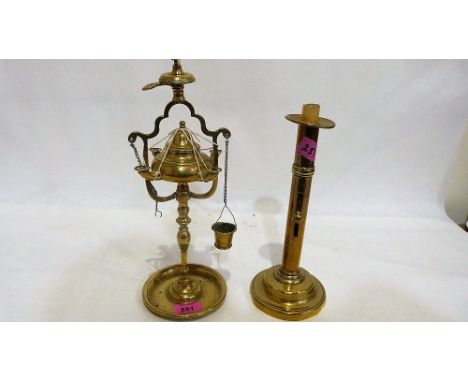 A brass ejector candlestick and a brass Roman style lamp