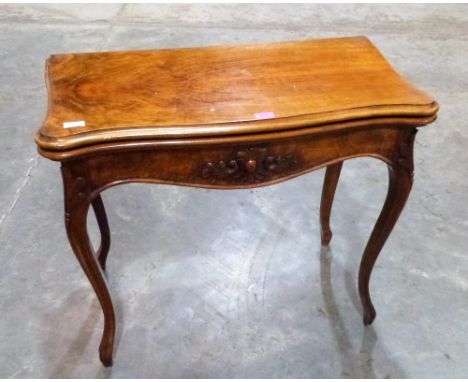 A 19th century walnut serpentine card table on French cabriole legs. 33'' wide