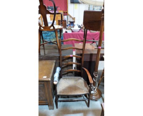 A ladder back elbow chair with rush seat