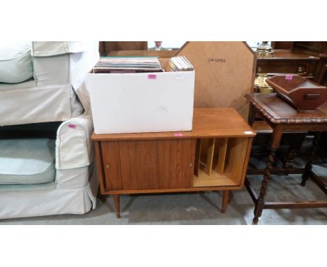 A 1960's record cabinet with a collection of long playing records