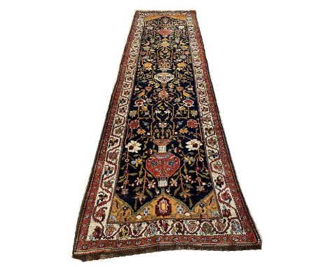 FINE ANTIQUE BIDJAR RUNNER, 425cm x 117cm, vase and bird design field, within a repeat rosette border. 