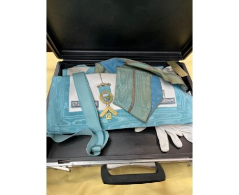 A briefcase containing 2 Masonic aprons, gloves, and a medal marked silver
