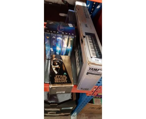 A Yamaha PSS 170 keyboard, a boxed set of Star Wars vhs tapes and a boxed set of Star Trek VHS cassettes