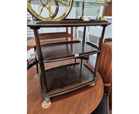 An Ercol dark elm three tier trolley. 