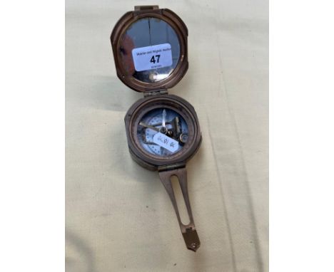 A brass military compass. 