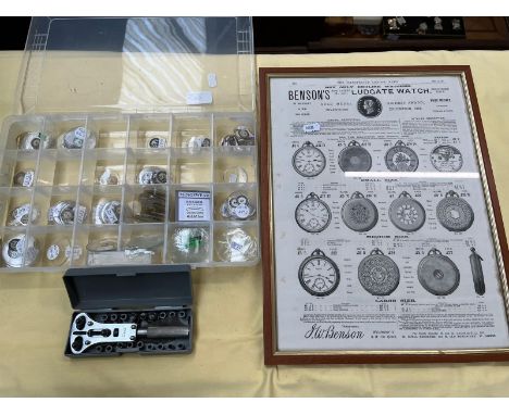 A tray of watch glasses, watch repairing tools, and a framed picture of vintage watches