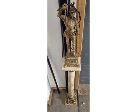 A brass figural lamp with onyx and gilt metal pedestal stand, height 162cm (overall)