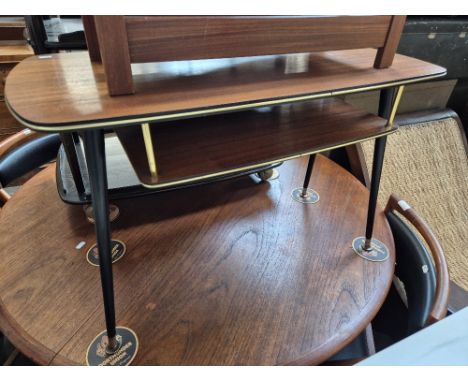 A mid 20th century coffee table with magazine rack/shelf.