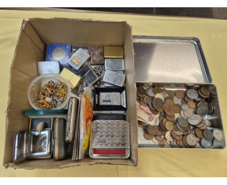 A box of assorted collectables and a tin of various world coins to include Zippo lighters, cufflinks and commemorative crowns