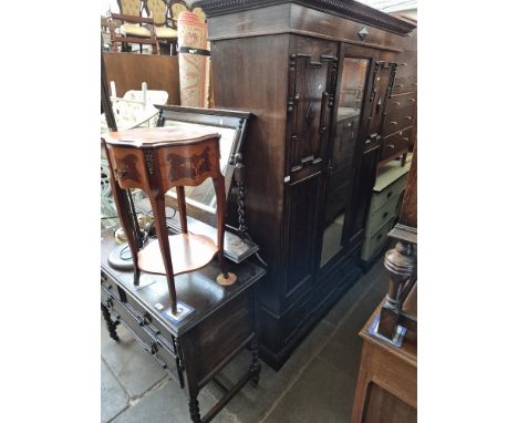 A 1920s oak dressing table, chest of drawers and matching wardrobe.