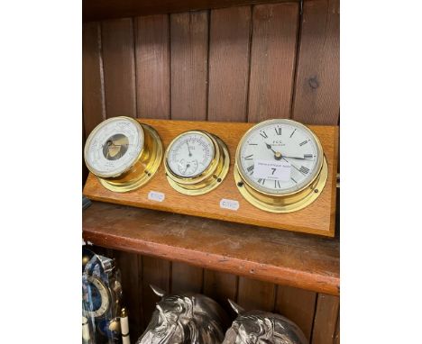 An FCC Precision clock, barometer and thermometer, mounted on oak back.