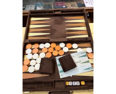 A backgammon set in a leather and suede case 